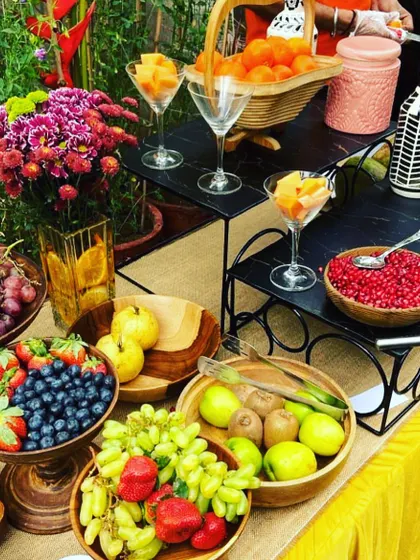 A vibrant and healthy fruit bar setup. This station is perfect for brunches or daytime events, offering a colourful assortment of fresh fruits and juices for guests to enjoy.