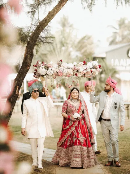 The bride's procession through a beautiful garden setting. Her makeup is flawless, ensuring she looks stunning from a distance and up close.