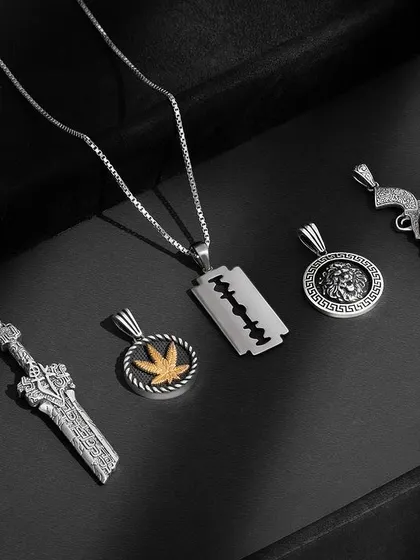 How cool are these pendants from Orionz Jewels? We shot them with moody lighting and a dark background to really bring out their masculine and edgy designs. Our favorites are the gun and the sword.