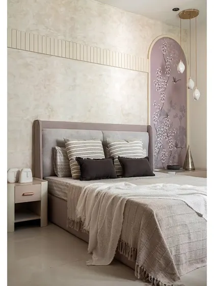 This guest bedroom in 'The Boho Escape' uses a calming blend of ivory, greige, and lavender. The feature wall combines textured paint, fluted paneling, and a beautiful floral wallpaper arch.
