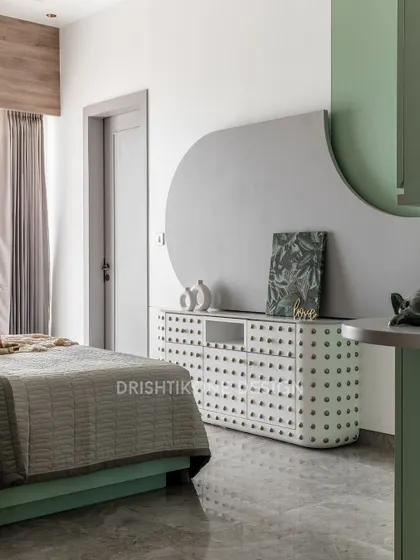 This nature-inspired bedroom features a unique cactus-themed credenza and soft green hues. The design uses curved shapes and gentle textures to create a calm and organic environment.