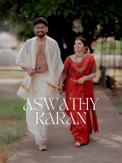 An elegant portrait of the couple walking hand-in-hand after their temple wedding, their traditional red and white attire looking timeless.