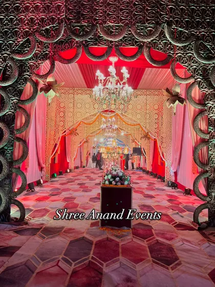 A head-on view through a grand archway, showing the layers of chandeliers and decor that create a deep, immersive experience for arriving guests.