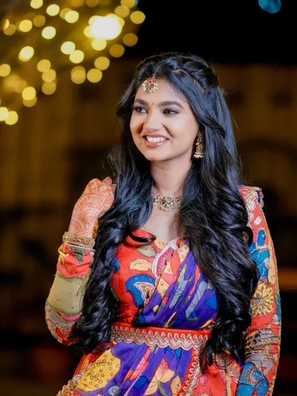 A lovely half-up hairstyle with a simple braid and soft waves. This is a classic look for a pre-wedding function, providing elegance without being overly formal.