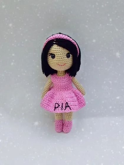 This is a custom doll I made, personalized with the name 'Pia' embroidered on her little pink dress. Adding a name is a sweet way to make a handmade gift even more special.