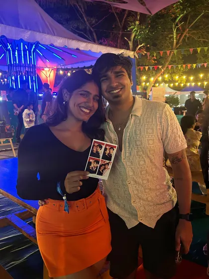 A sweet moment for a couple at an outdoor event. Holding up their photo strip, they have a personal souvenir to remember their date night. Our booth offers a little private moment amidst the buzz of a big crowd.