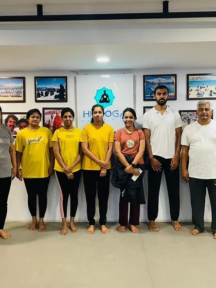 A group photo with students celebrating International Yoga Day.