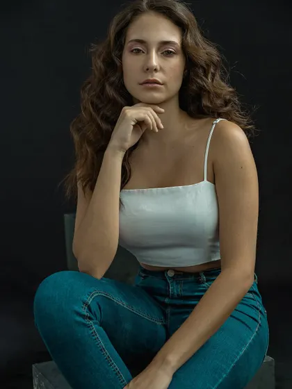 A seated portrait from the same session, showing a calm and confident presence. This type of shot is perfect for a model's portfolio, highlighting their natural look.