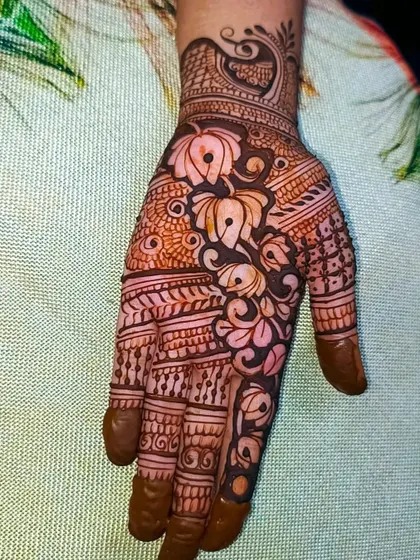 A still image of the beautiful lotus mehndi design. The contrast between the filled and empty spaces makes the lotus flowers the central focus of this intricate piece.