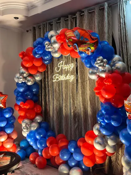 Another angle of the car-themed ring decoration, showing how it creates a perfect photo backdrop in a living room.