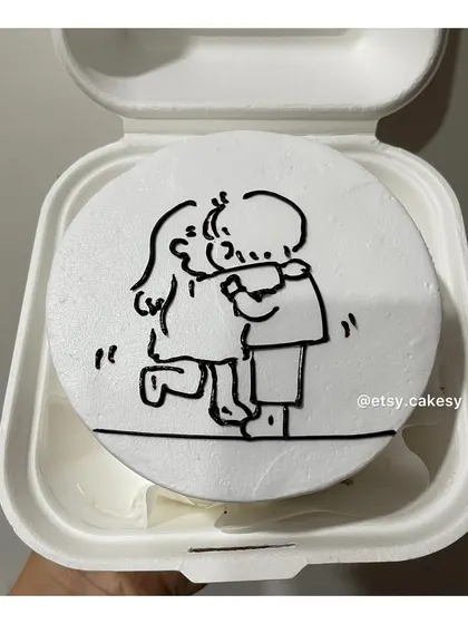 A simple and touching line-art drawing of a couple hugging on a bento cake.
