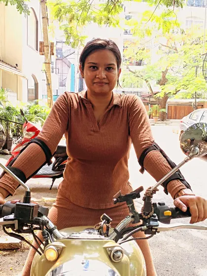 A graduate looking confident and stylish on her bike. Our training helps you find your power and express your personality as a rider.
