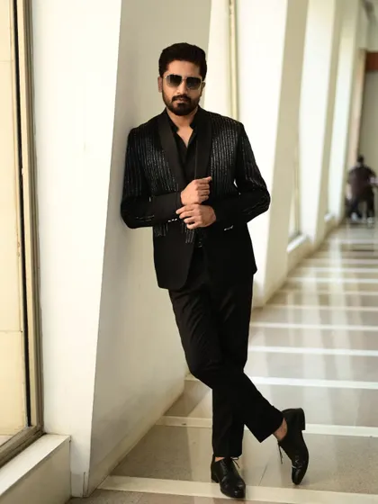 A full-length shot of a client in our black sequin blazer, showcasing its tailored fit and contemporary style.