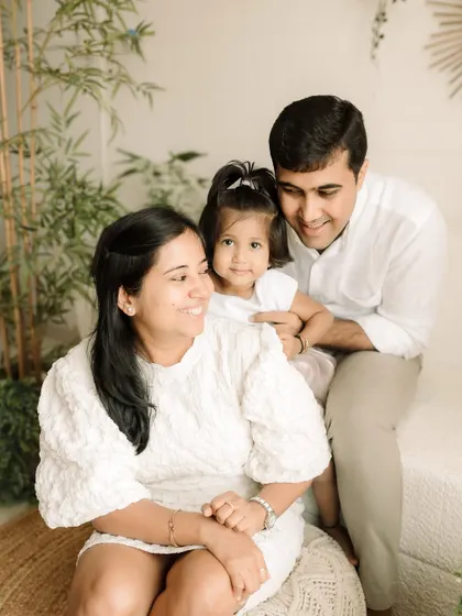 A relaxed family portrait where everyone is comfortable and looking at the camera, showing a different side of our indoor sessions.