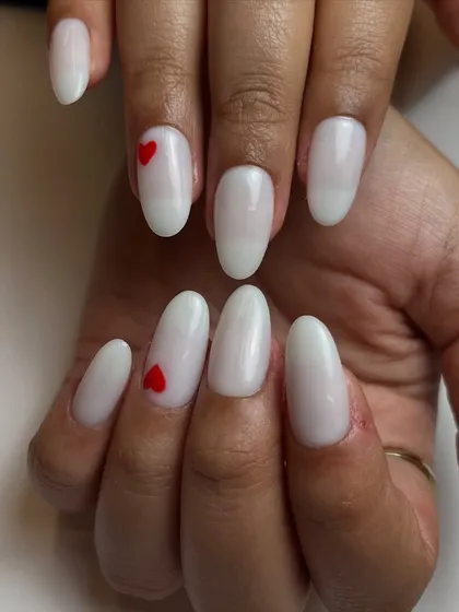 Why not romanticize everything? This sweet and simple design features a clean, milky white base with a tiny, perfectly placed red heart accent nail.