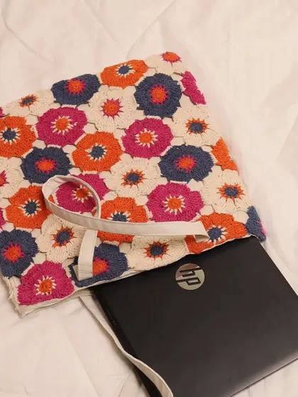 This image shows how a laptop fits snugly inside the tote. I made sure the dimensions are generous, so it can function as your go-to work or student bag without sacrificing its bohemian style.