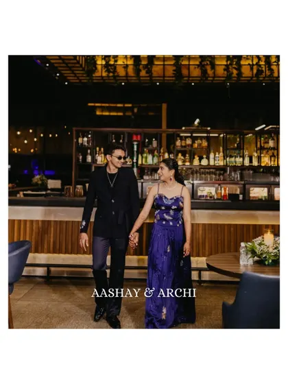 A stylish shot of the couple walking hand-in-hand through a chic bar setting during their cocktail party. It has a modern, urban vibe that’s perfect for pre-wedding celebrations.