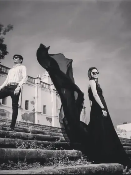 A high-fashion, dramatic black and white shot of a couple on old stone steps, creating a very stylish look.