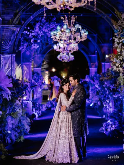 A love letter written in moonlight. For this Sangeet, we used dramatic blue uplighting, lush florals, and elegant chandeliers to create a romantic and poetic atmosphere for the couple's portraits.