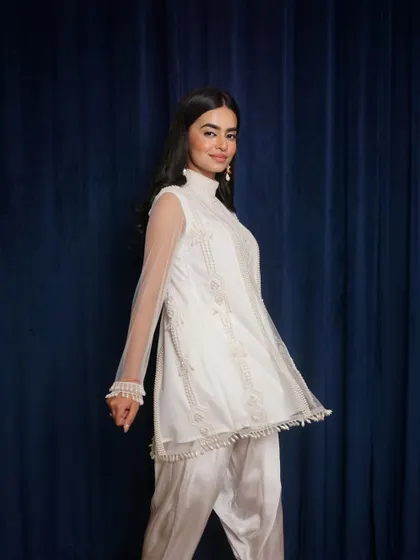 A candid, in-motion shot that shows the light and airy feel of the white organza outfit. This captures the personality of the garment.
