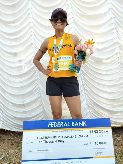 Posing with the prize check after the Kochi Half Marathon. This was a special win on my birthday.