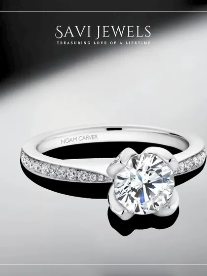 A floral-inspired solitaire that feels delicate yet significant. This ring features a brilliant round diamond held in a unique petal-like setting, a beautiful symbol of a love in bloom.