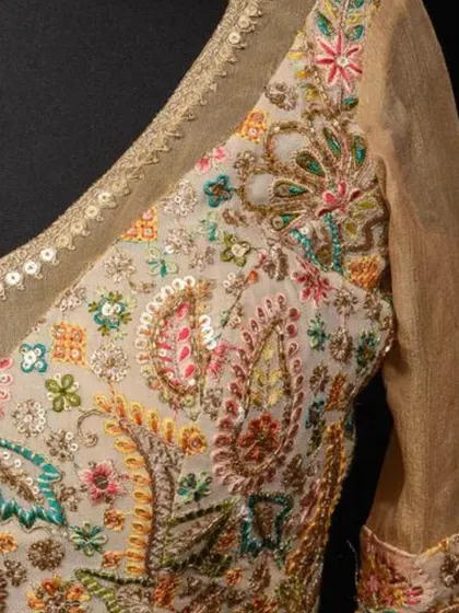 A close-up of the exquisite, multi-colored floral and paisley embroidery on our cream georgette blouse.