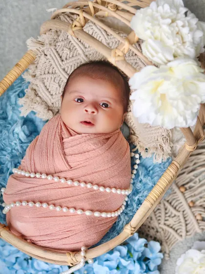 A direct and engaging portrait of an awake baby looking right at the camera. These expressive shots are a treasure for parents.