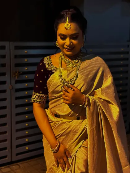 A candid shot from an evening photoshoot, showing how the makeup and silk saree catch the light.
