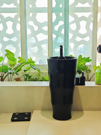 Bringing greenery into the bathroom. A small window ledge is the perfect spot for plants that thrive in humidity, creating a spa-like feel.
