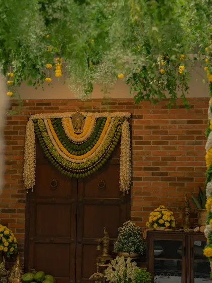 A wider view of the entrance, where the lush green canopy and the detailed floral toran come together. My goal is always to create a cohesive visual story that starts from the moment your guests walk in.
