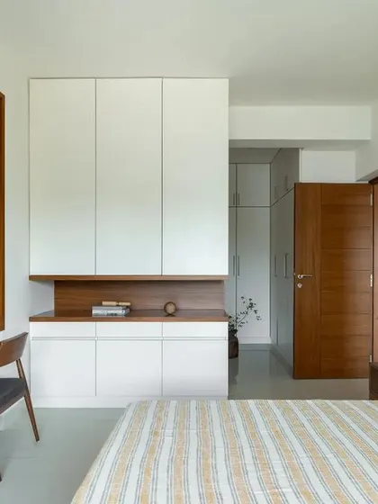 Another view of the bedroom, showing the layered design of the wardrobe and study nook, all within a clean and contemporary framework.