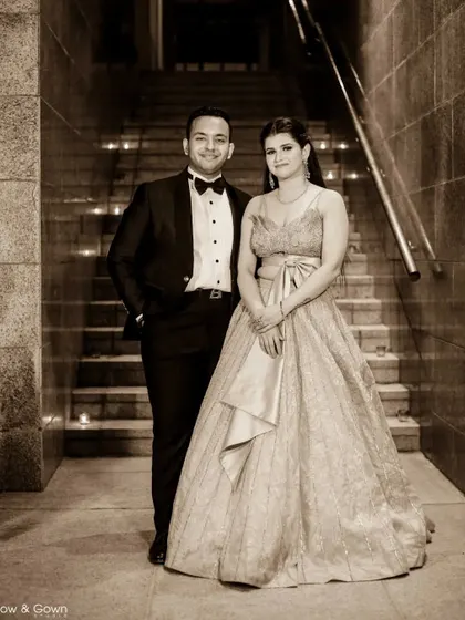 A classic, formal portrait of the couple on their engagement day. The sepia tone and the grand staircase setting give this photo a timeless, elegant feel.