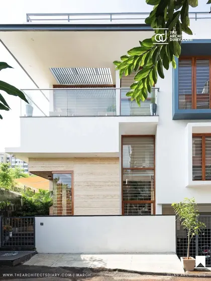 The completed Cube House, where stacked and staggered cubic volumes create a unique architectural form. The use of travertine cladding on the ground floor anchors the otherwise lightweight structure.
