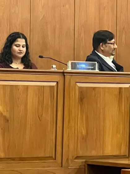 Our Associate, Drishti Kardam, seated on the panel, preparing to share her insights on how IP drives sustainable development.