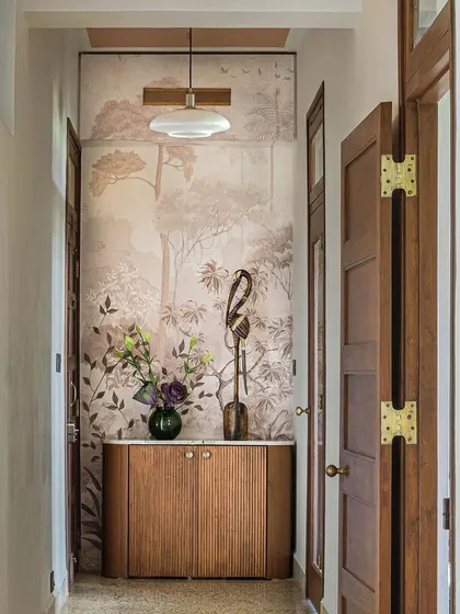 The corridor in Apartment 5026, where a beautiful, nature-inspired wallpaper creates a stunning focal point. This space serves as a perfect example of how we use art and design to transform functional areas into memorable vistas.