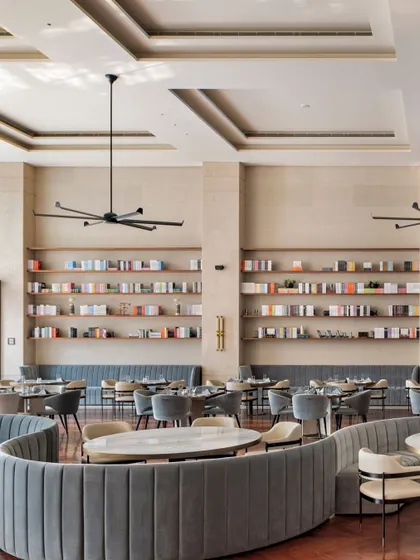 Curvilinear seating is a key feature in the Elevate Clubhouse, used to soften the geometry of the large space and create more natural, flowing conversation pits. This approach helps to make a grand room feel more intimate and approachable.