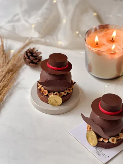 Our dapper "Gentleman" entremet for Father's Day, shaped like a man with a chocolate hat and mustache. This individual dessert is layered with espresso mousse, caramel, and dark chocolate.