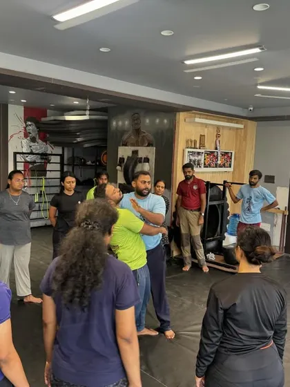The workshop in session, with participants listening intently to the coach's instructions. A safe and respectful learning environment is our top priority.