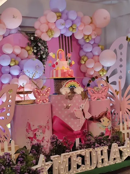 A butterfly-themed first birthday party setup.