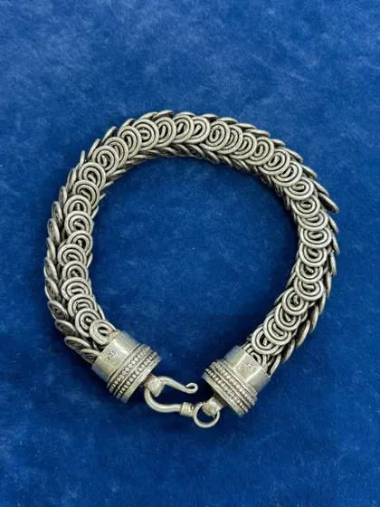 A full view of our unisex silver chainmail-style bracelet. The intricate, interlocking ring design gives it a substantial feel and a unique texture, making it a statement piece for anyone.