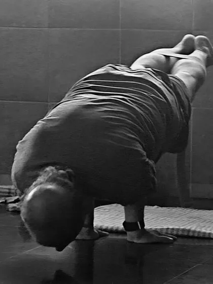 Mayurasana (Peacock Pose), a challenging arm balance that strengthens the entire digestive system and builds immense power in the wrists, arms, and abdomen.