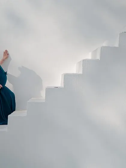 A moment of quiet reflection. This elegant solo maternity portrait showcases the beauty and strength of motherhood. We provide a selection of beautiful gowns to help you feel your best during the shoot.