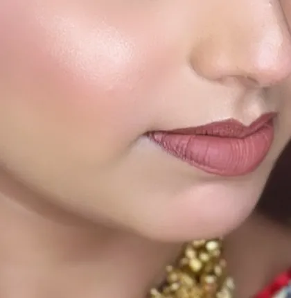 A close-up of the skin finish and lip color. I focus on creating a base that looks like second skin, glowing and healthy.
