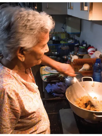 Archit's Amma (paternal grandmother) in her kitchen. Her cooking relies on senses rather than precise measurements, a beautiful example of intuitive, generational knowledge.