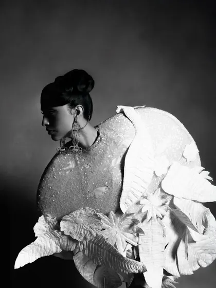 A black and white profile portrait for designer Rahul Mishra's collection, featured in Hindustan Times. This shot focuses on the sculptural quality of the garment and the model's strong silhouette, creating a dramatic, high-fashion editorial image.