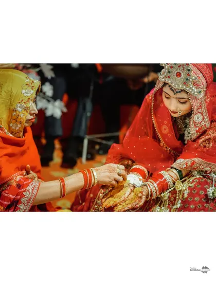 A close-up of a wedding ritual, showing the bride's hands during a ceremony. This shot emphasizes the traditions and cultural details that are central to an Indian wedding.
