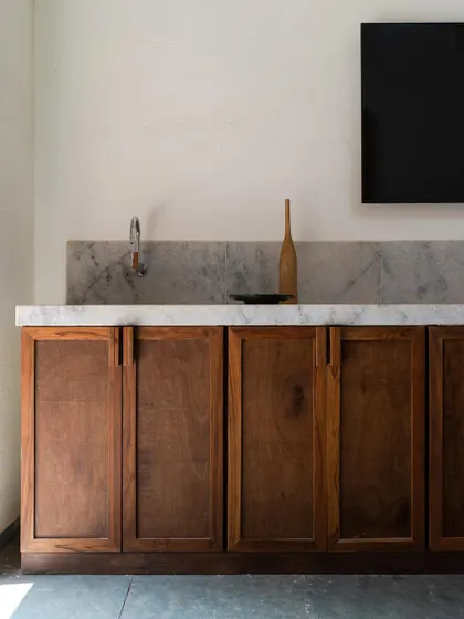 A simple yet elegant wooden cabinet in Maison Rouge, showcasing the beauty of natural timber and traditional craftsmanship.