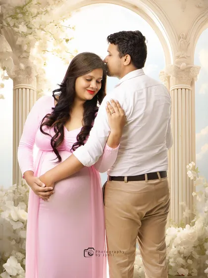 A heavenly-themed couple's portrait with a digitally created background of white arches and clouds. This is an example of the fairytale-style edits I can create.