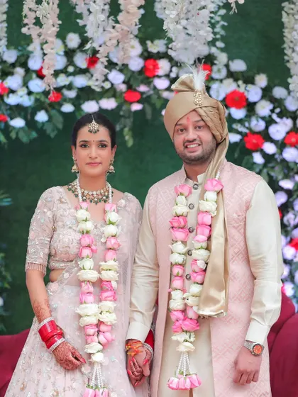 A classic portrait of the couple after their jaimala ceremony, posing for the camera.